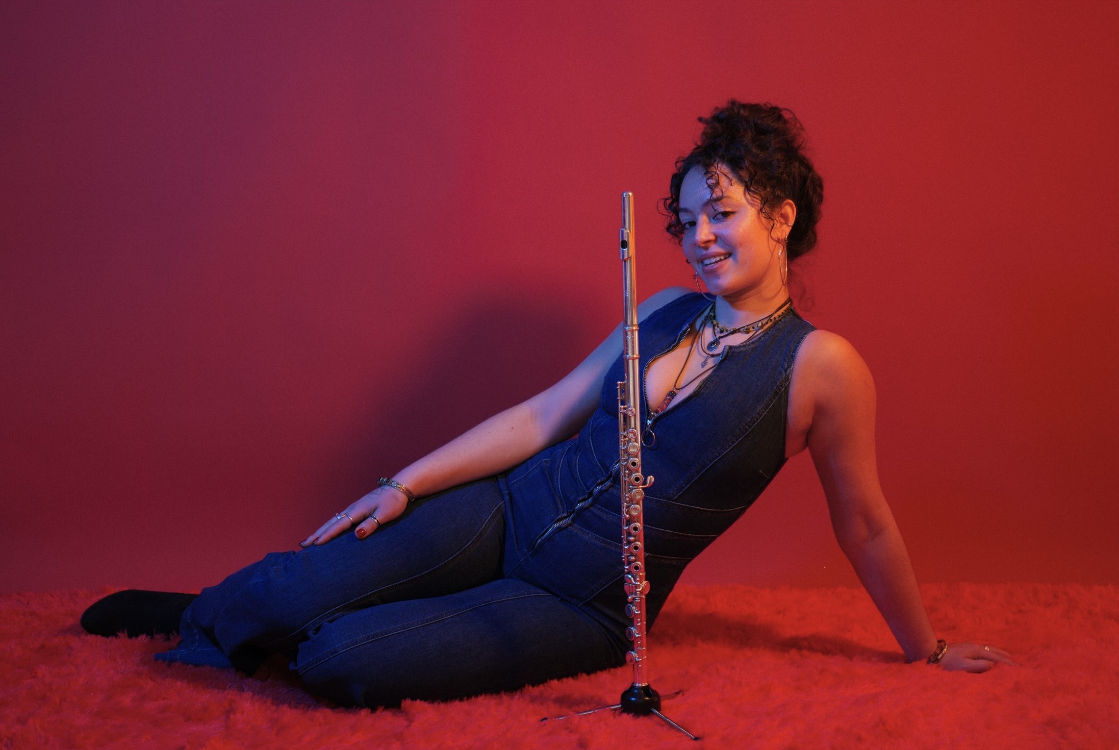 Rabiah Kabir seated with her flute